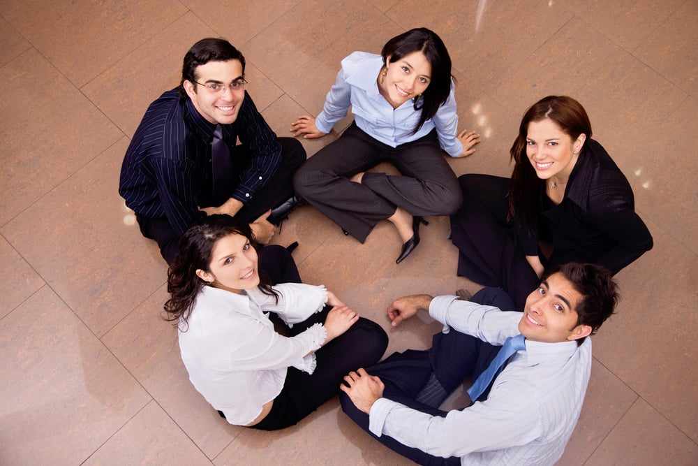 Business group sitting on the floor on a circle